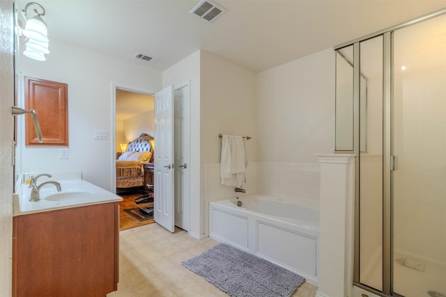 bathroom featuring vanity and separate shower and tub