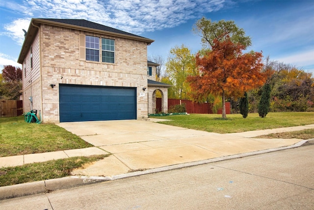 view of front property featuring a garage and a front yard