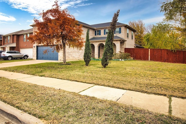 view of front of house featuring a garage and a front lawn