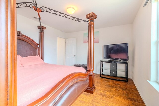 bedroom with wood-type flooring