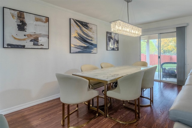 dining area featuring ornamental molding, dark wood-type flooring, and a chandelier