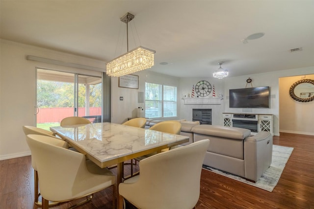 dining area with an inviting chandelier and dark hardwood / wood-style floors