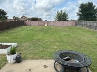 view of yard featuring an outdoor fire pit and a patio