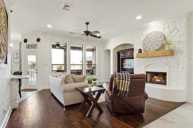 kitchen featuring appliances with stainless steel finishes, dark brown cabinetry, crown molding, light tile patterned floors, and hanging light fixtures