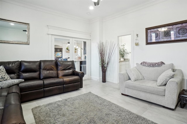 tiled living room featuring ceiling fan, ornamental molding, and french doors