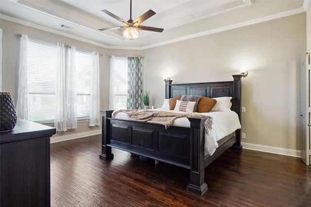 bedroom featuring a raised ceiling, ceiling fan, crown molding, and dark wood-type flooring