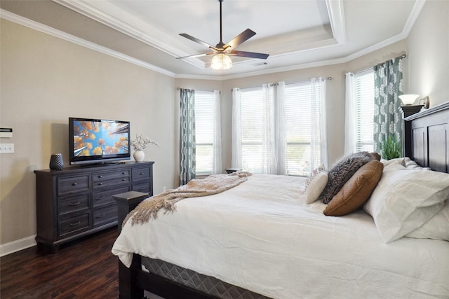 bedroom featuring crown molding, ceiling fan, dark hardwood / wood-style floors, and a raised ceiling