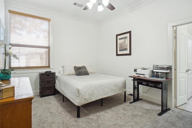 carpeted bedroom featuring ceiling fan and ornamental molding