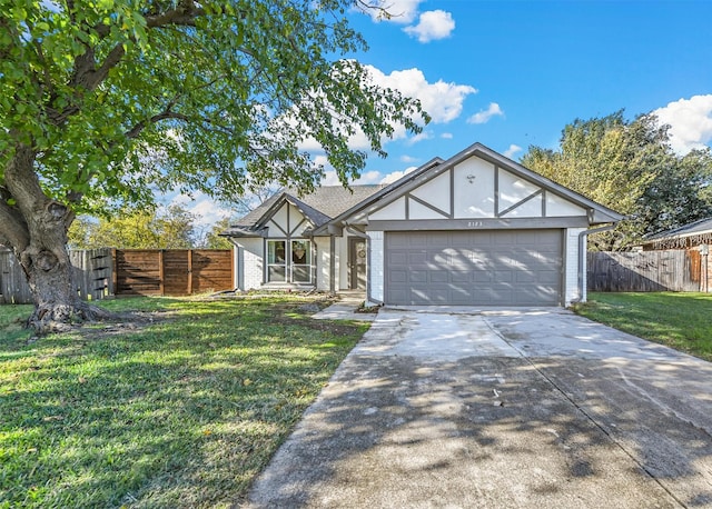 view of front of home with a front yard and a garage