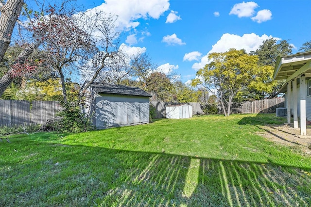 view of yard with a storage shed and central AC