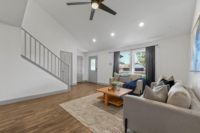 living room featuring ceiling fan, wood-type flooring, and lofted ceiling