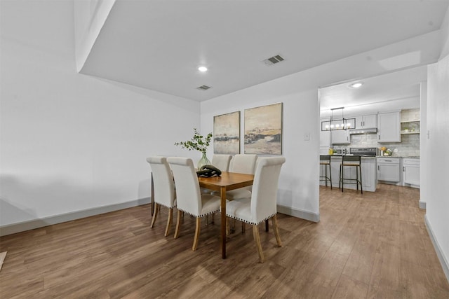 dining area featuring light wood-type flooring