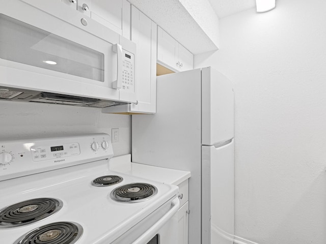 kitchen with white cabinets and white appliances