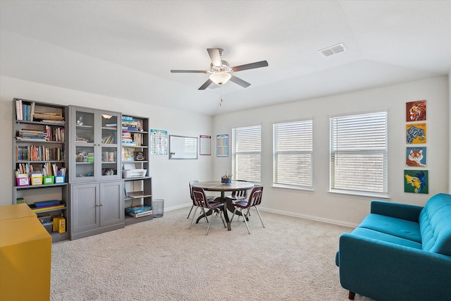 carpeted office space with ceiling fan