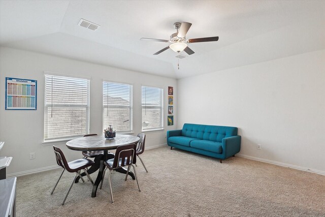 carpeted dining room featuring ceiling fan and lofted ceiling