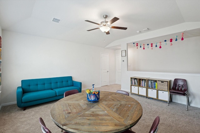 dining area featuring ceiling fan, lofted ceiling, and light carpet