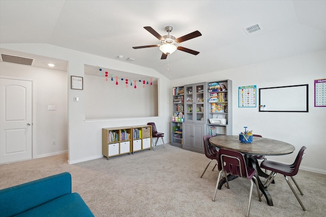 dining room featuring light carpet, ceiling fan, and vaulted ceiling