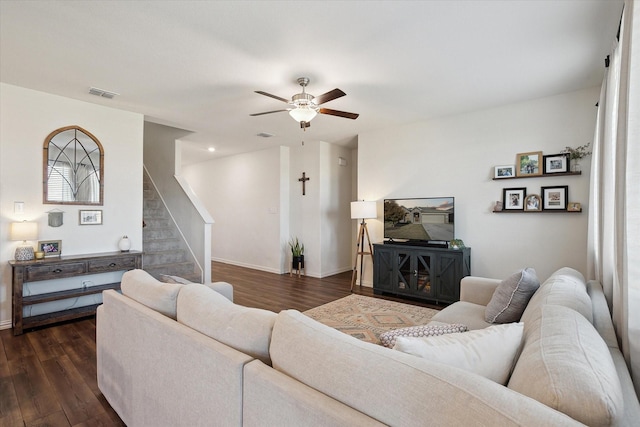 living room with dark hardwood / wood-style flooring and ceiling fan