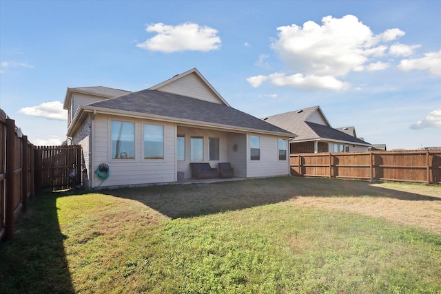 rear view of property featuring an outdoor hangout area and a yard