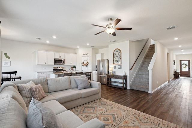 living room with dark wood-type flooring and ceiling fan