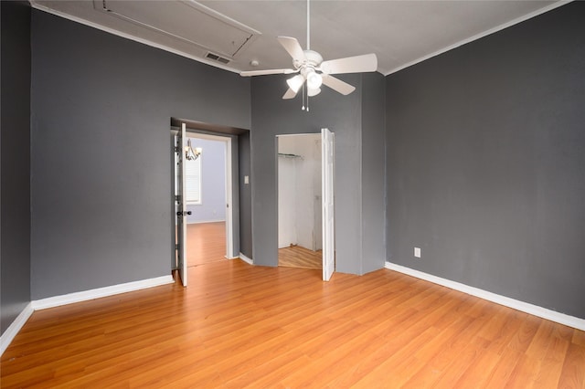 unfurnished room with ceiling fan with notable chandelier, crown molding, and light hardwood / wood-style flooring