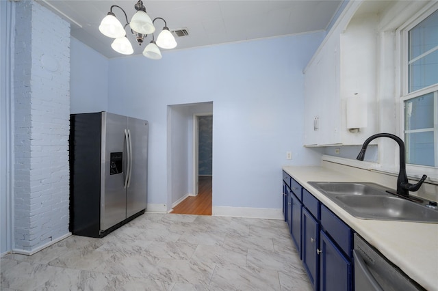 kitchen with pendant lighting, an inviting chandelier, sink, ornamental molding, and appliances with stainless steel finishes