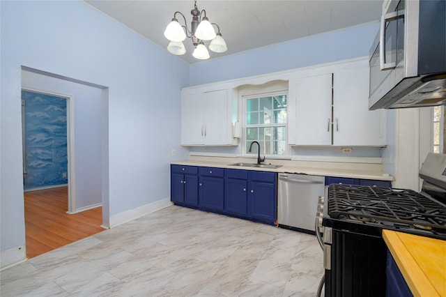 kitchen featuring white cabinets, appliances with stainless steel finishes, a healthy amount of sunlight, and sink