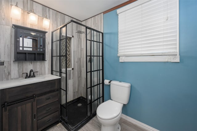 bathroom featuring tiled shower, hardwood / wood-style floors, vanity, and toilet