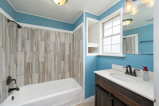 bathroom with vanity and tiled shower / bath combo