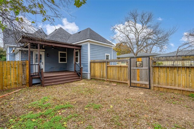 back of house featuring a wooden deck and ceiling fan