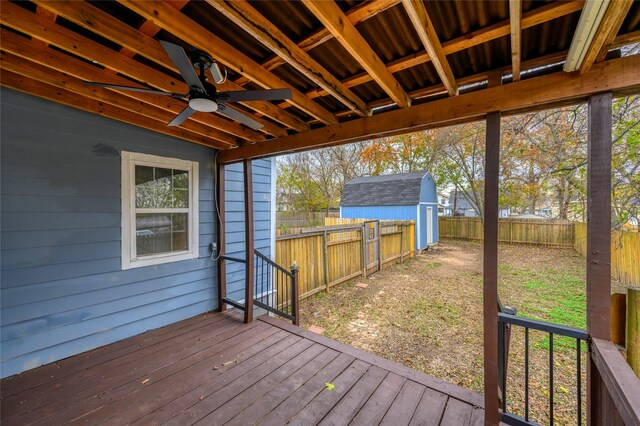 wooden deck with ceiling fan and a storage shed