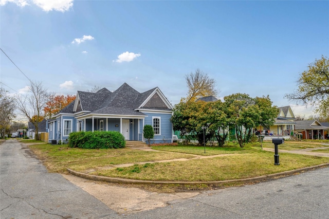 view of front of house featuring a front lawn and central AC unit