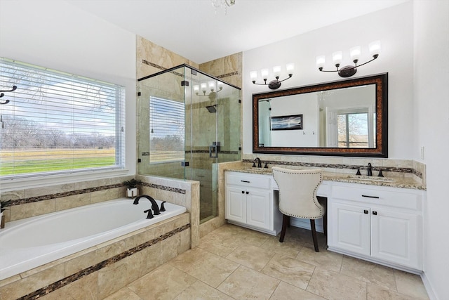 full bathroom with double vanity, a garden tub, a shower stall, and a sink