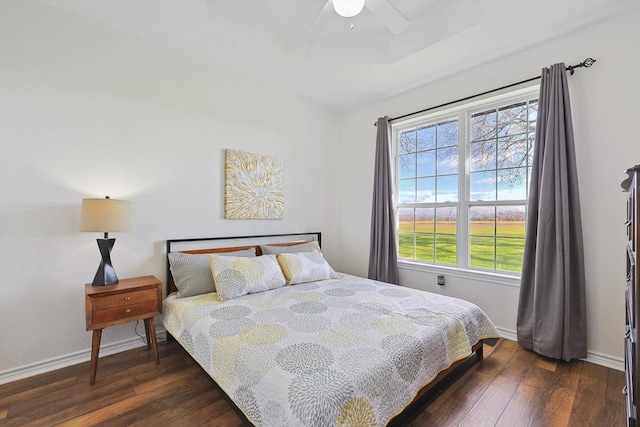 bedroom with a ceiling fan, baseboards, and hardwood / wood-style floors