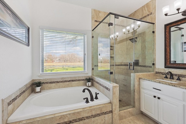 full bathroom featuring a garden tub, a shower stall, and vanity