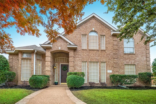 front facade with a front yard