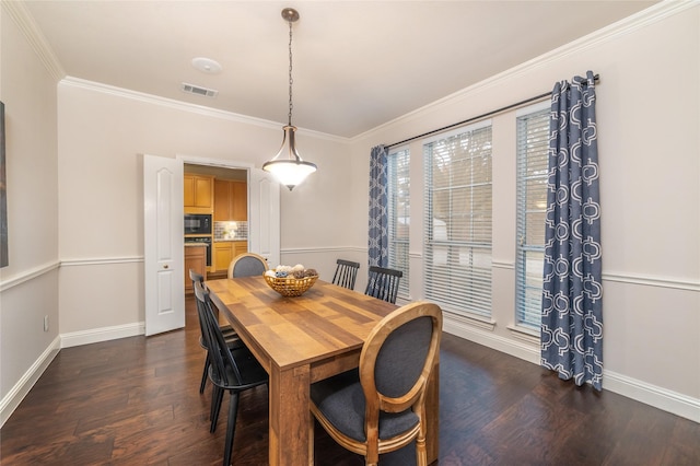 dining room with crown molding and dark wood-type flooring