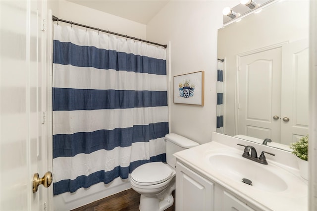 bathroom featuring curtained shower, vanity, wood-type flooring, and toilet