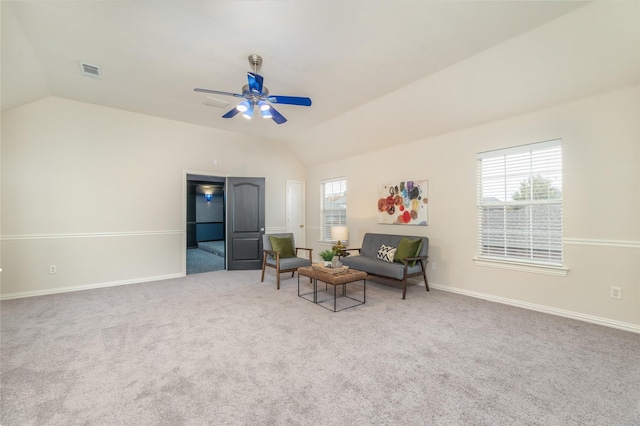 living area with ceiling fan, carpet, and lofted ceiling