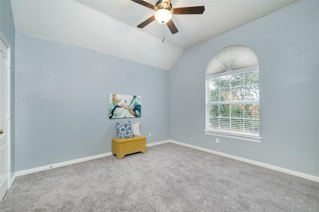 carpeted spare room featuring ceiling fan and vaulted ceiling