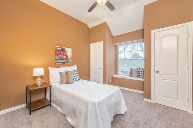 bedroom featuring ceiling fan, light colored carpet, and lofted ceiling