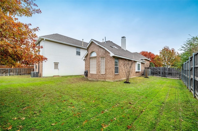 back of property with a lawn and cooling unit