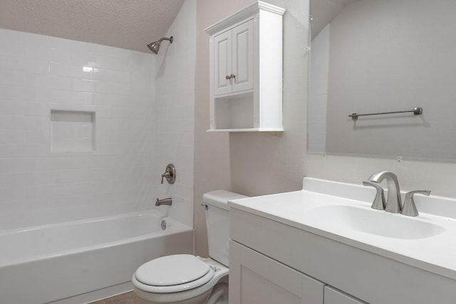 full bathroom with vanity, a textured ceiling, toilet, and tiled shower / bath combo