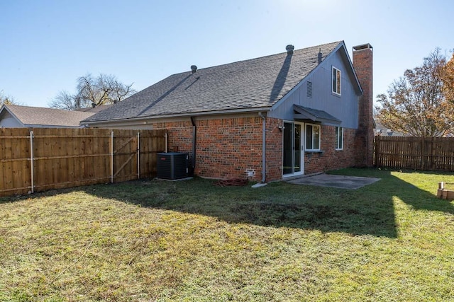 back of house featuring a yard, cooling unit, and a patio area