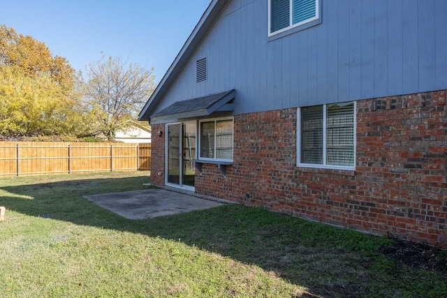 exterior space with a patio area and a lawn