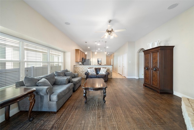 living room featuring ceiling fan and dark hardwood / wood-style flooring