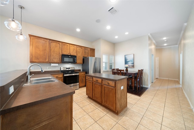 kitchen featuring sink, decorative light fixtures, light tile patterned floors, crown molding, and appliances with stainless steel finishes