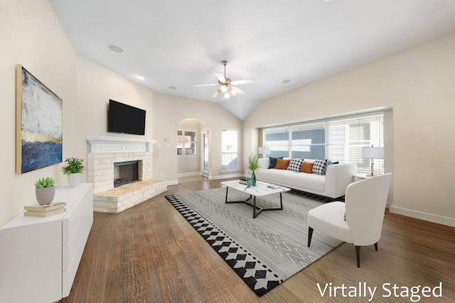 1125 Appalachian Ln, Savannah, TX 76227 - living room with arched walkways, baseboards, ceiling fan, wood finished floors, and a fireplace