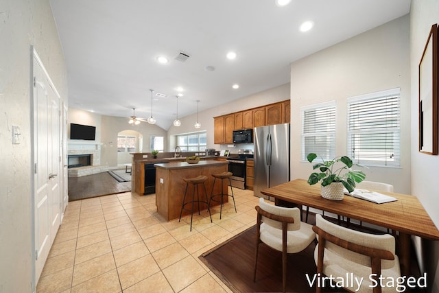 1125 Appalachian Ln, Savannah, TX 76227 - kitchen with appliances with stainless steel finishes, a center island, dark countertops, a sink, and open floor plan