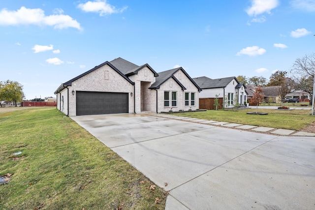 french country style house with a garage and a front yard